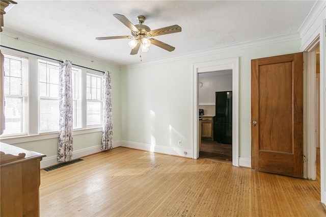 unfurnished room featuring crown molding, ceiling fan, and light hardwood / wood-style flooring