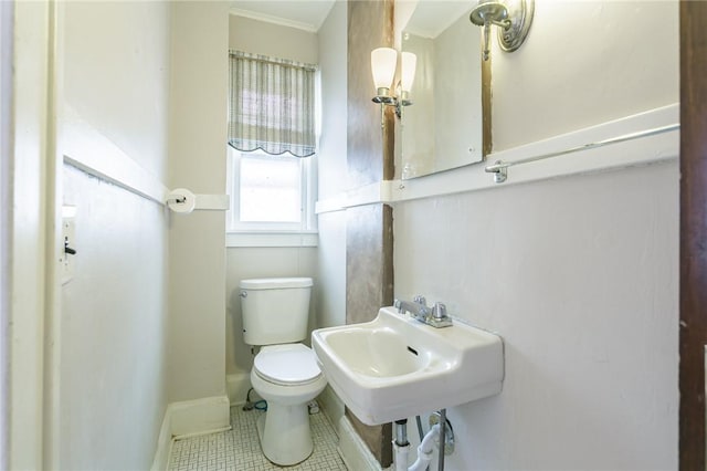 bathroom with tile patterned flooring, sink, and toilet