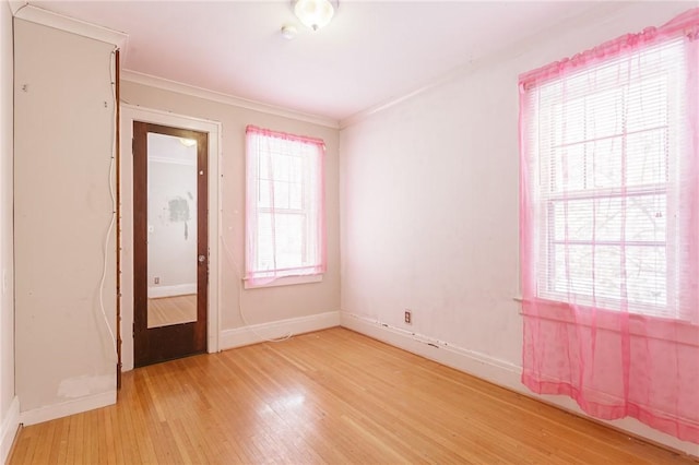 unfurnished room featuring wood-type flooring and ornamental molding