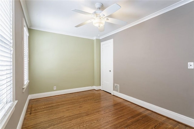 empty room featuring wood-type flooring, ornamental molding, and ceiling fan