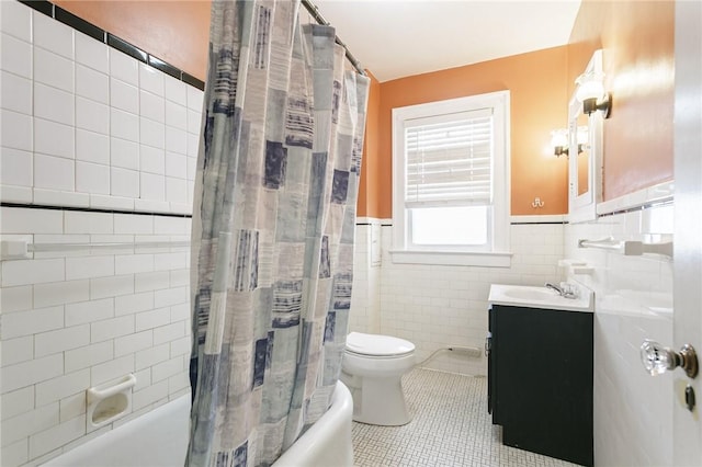 full bathroom with tile walls, tile patterned flooring, vanity, toilet, and shower / bath combo