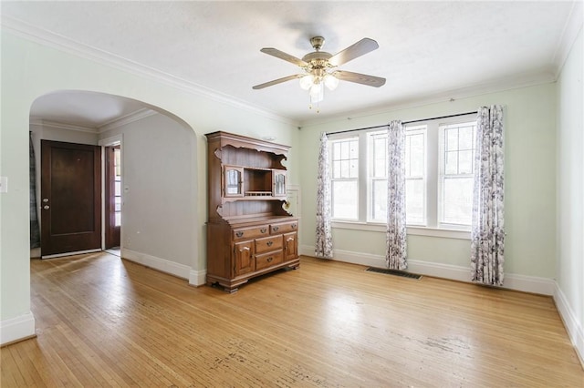 empty room featuring crown molding, ceiling fan, and light hardwood / wood-style flooring