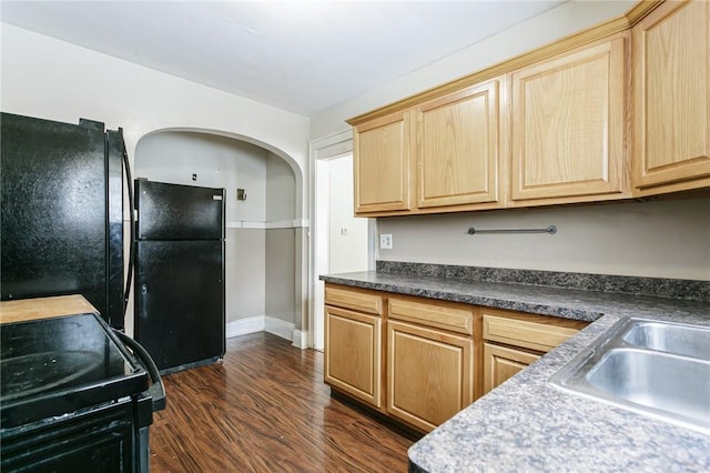 kitchen with sink, dark wood-type flooring, black appliances, and light brown cabinets