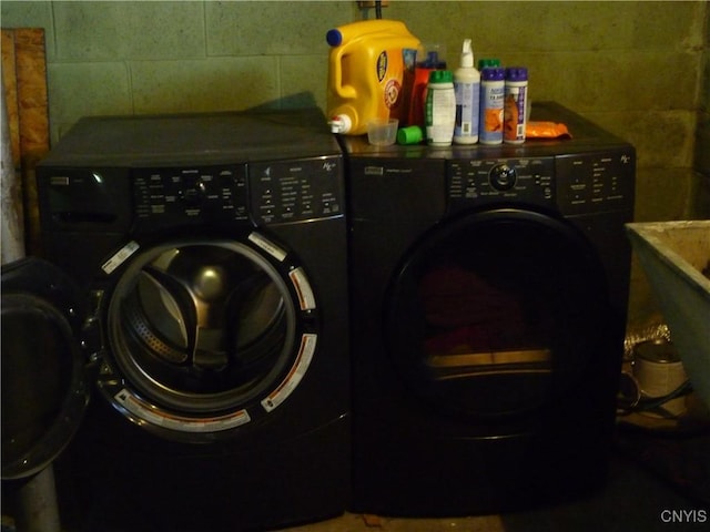 clothes washing area featuring washing machine and clothes dryer