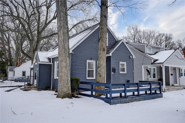 view of snow covered rear of property