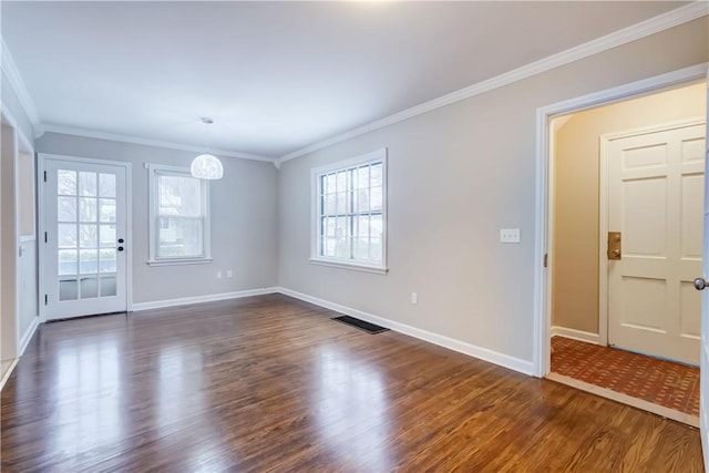 spare room featuring crown molding and dark hardwood / wood-style floors