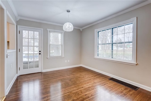 unfurnished dining area with ornamental molding, hardwood / wood-style floors, and a notable chandelier