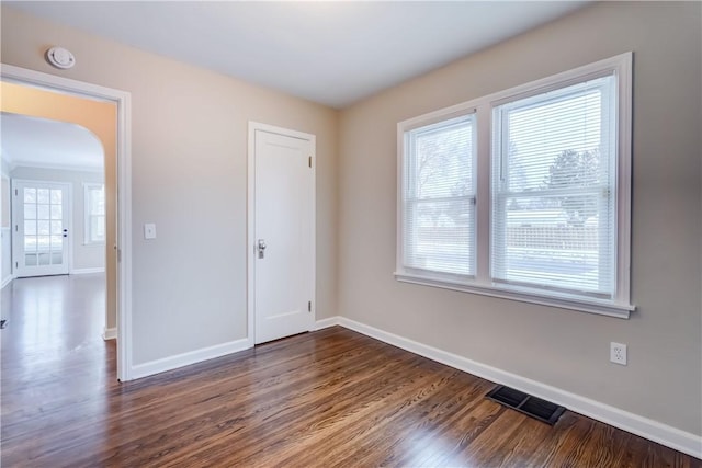 spare room featuring dark hardwood / wood-style flooring