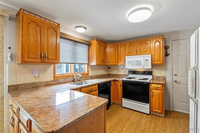 kitchen featuring sink, white appliances, tasteful backsplash, kitchen peninsula, and light wood-type flooring