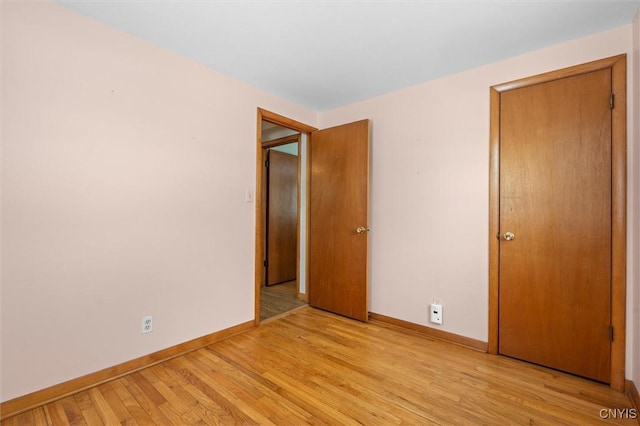 unfurnished bedroom with light wood-type flooring