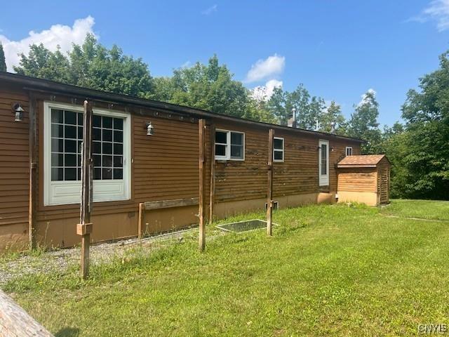 view of side of property with a lawn