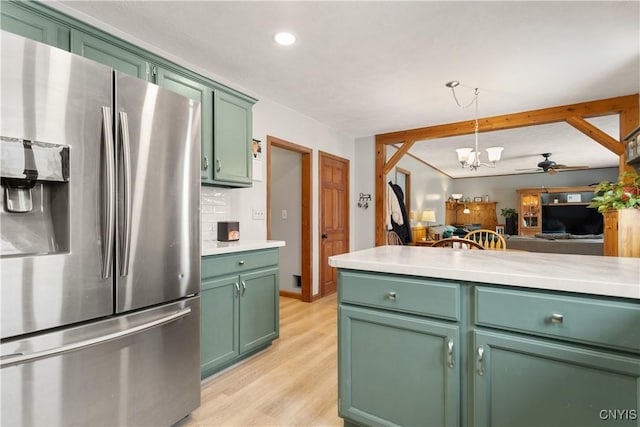 kitchen with stainless steel fridge with ice dispenser, decorative light fixtures, tasteful backsplash, green cabinetry, and light hardwood / wood-style flooring