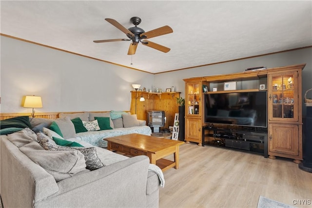 living room featuring crown molding, ceiling fan, and light hardwood / wood-style floors