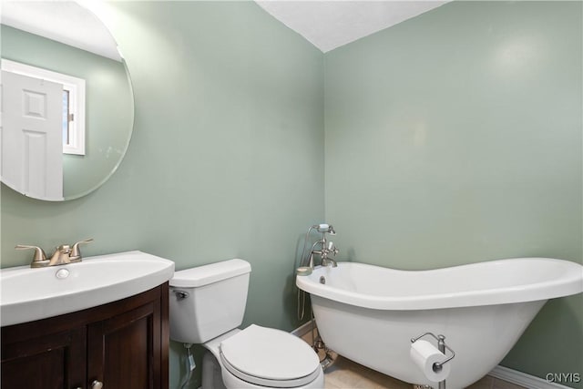 bathroom with vanity, a washtub, and toilet