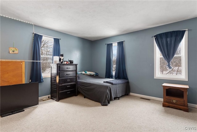 bedroom with carpet and a textured ceiling