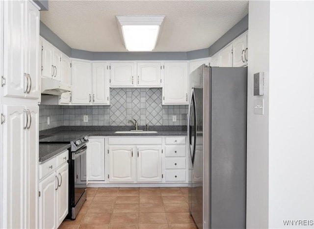 kitchen featuring stainless steel appliances, sink, white cabinets, and backsplash