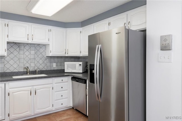 kitchen featuring white cabinetry, stainless steel appliances, and sink