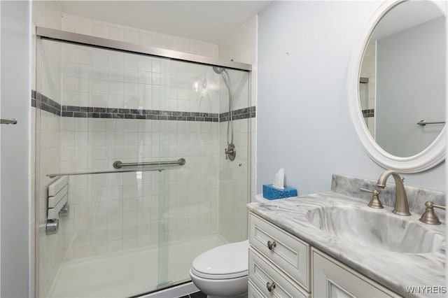 bathroom with vanity, toilet, and walk in shower