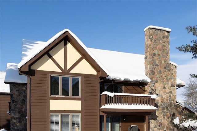 view of snowy exterior featuring a balcony