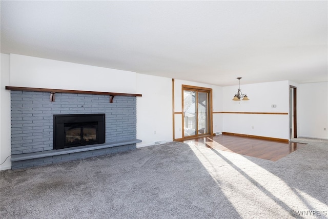 5293E Chestnut Ridge Rd Unit E, Orchard Park, NY 14127 - unfurnished living room with carpet flooring, a brick fireplace, and baseboards
