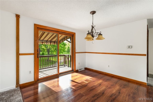 5293E Chestnut Ridge Rd Unit E, Orchard Park, NY 14127 - empty room featuring a chandelier, baseboards, wood finished floors, and a textured ceiling