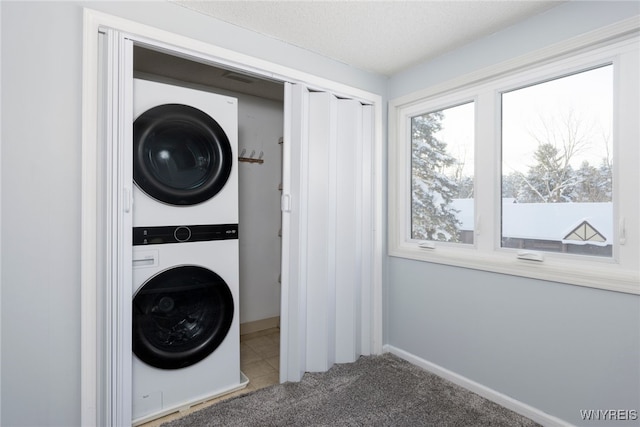 5293E Chestnut Ridge Rd Unit E, Orchard Park, NY 14127 - laundry area with stacked washer and clothes dryer, carpet floors, and baseboards