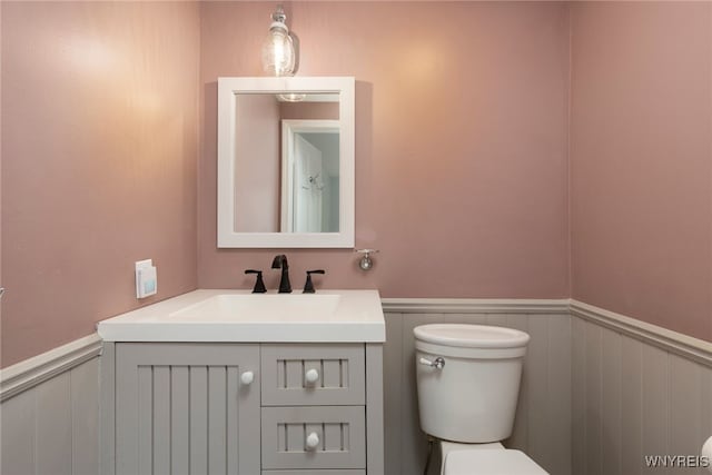 5293E Chestnut Ridge Rd Unit E, Orchard Park, NY 14127 - half bath with toilet, a wainscoted wall, vanity, and a decorative wall