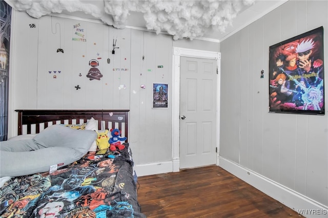 bedroom featuring crown molding and dark hardwood / wood-style flooring