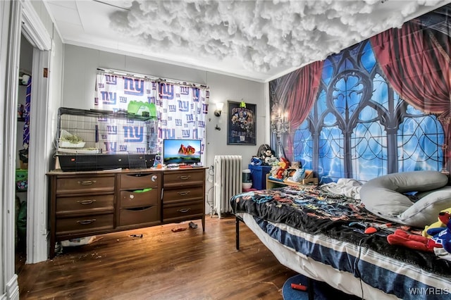 bedroom with ornamental molding, dark hardwood / wood-style flooring, and radiator