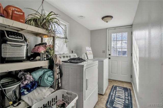 clothes washing area featuring independent washer and dryer