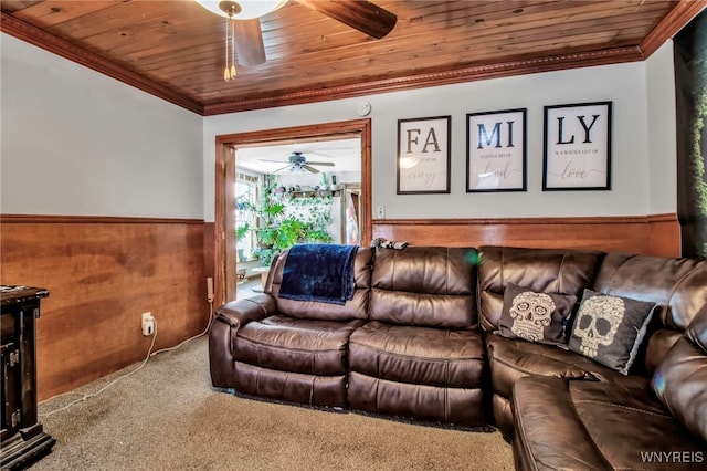 living room with crown molding, wood ceiling, ceiling fan, and wood walls