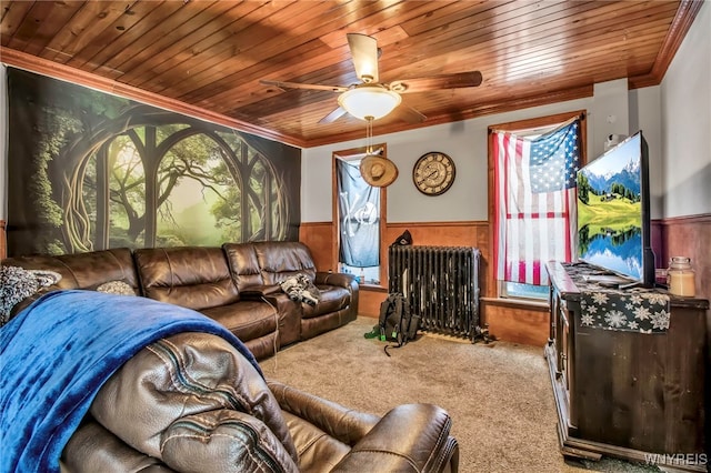 carpeted living room featuring wood ceiling, ornamental molding, radiator heating unit, and wooden walls