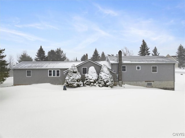 view of snow covered back of property