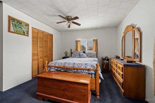 carpeted bedroom featuring a closet and ceiling fan