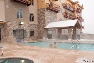 view of pool with sink and a patio