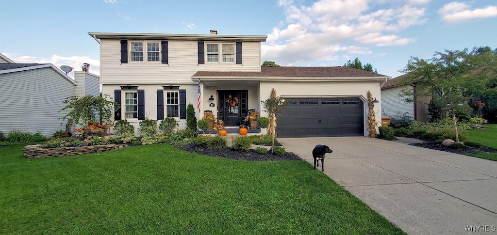 view of front of property featuring a garage and a front yard