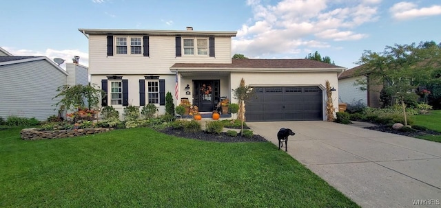 view of front of property featuring a garage and a front yard