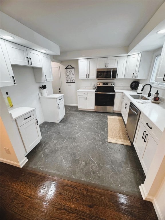 kitchen featuring sink, stainless steel appliances, and white cabinets