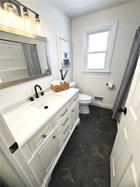 bathroom with vanity and toilet