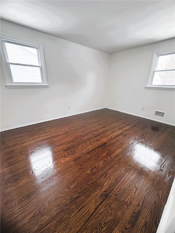 empty room with dark hardwood / wood-style floors