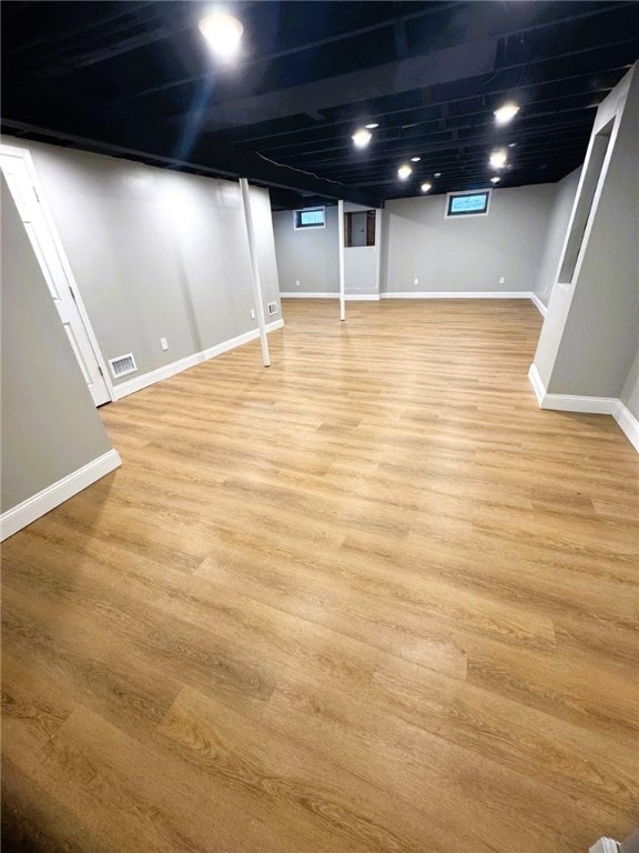 basement with light hardwood / wood-style floors