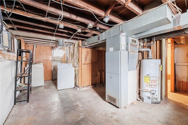 basement with water heater, separate washer and dryer, and heating unit