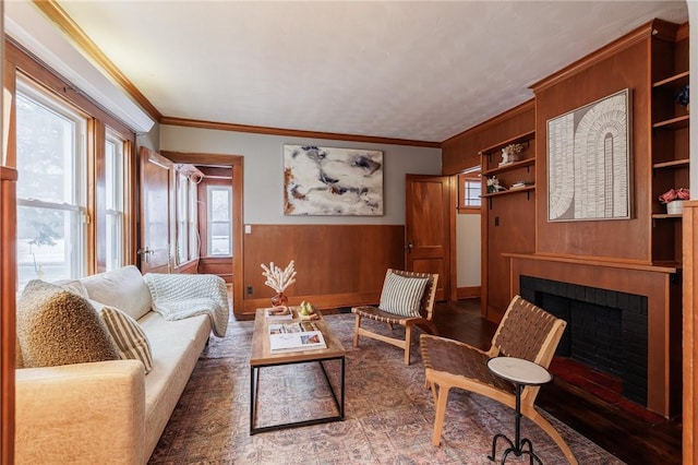 living room featuring crown molding and wood walls