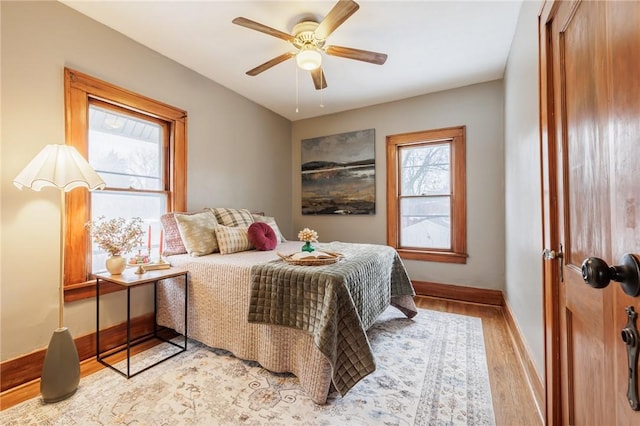 bedroom with ceiling fan and light hardwood / wood-style floors