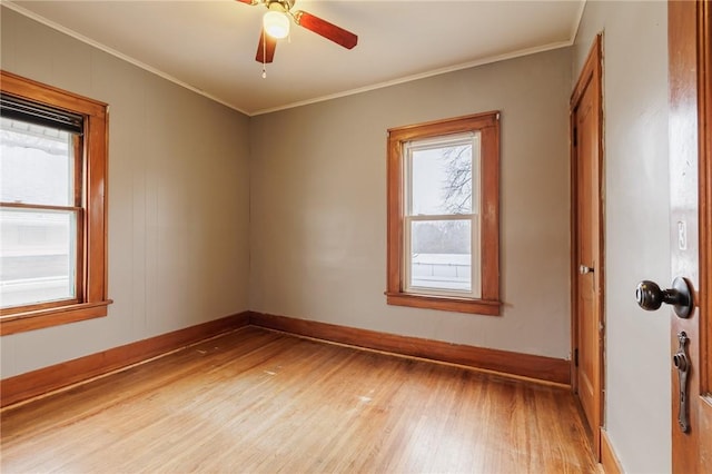 spare room featuring ornamental molding, ceiling fan, and light hardwood / wood-style floors