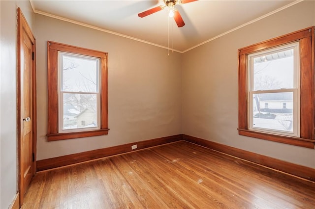 unfurnished room with ornamental molding, hardwood / wood-style floors, and ceiling fan