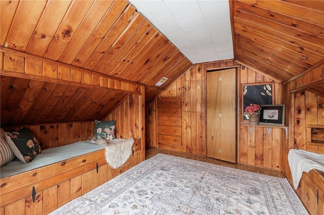 bedroom featuring wood ceiling and wood walls