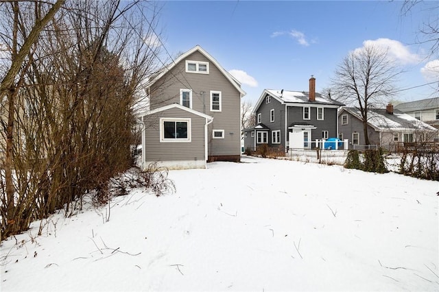 view of snow covered back of property