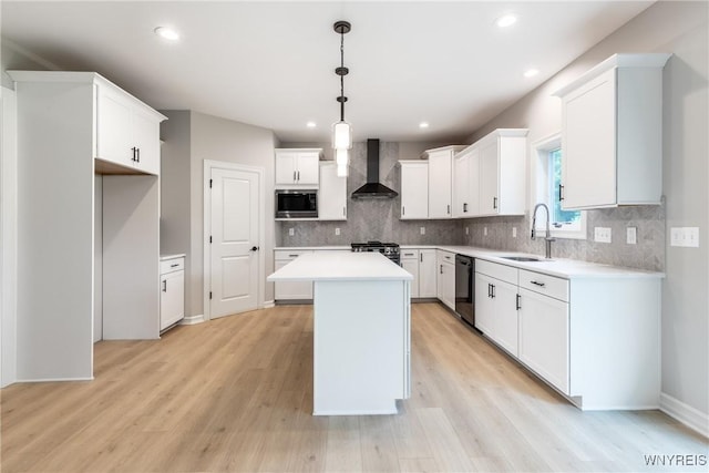 kitchen with built in microwave, wall chimney exhaust hood, sink, a center island, and white cabinets