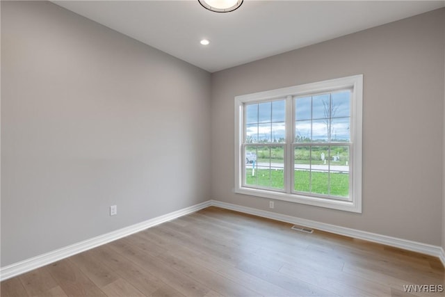 spare room featuring light hardwood / wood-style flooring